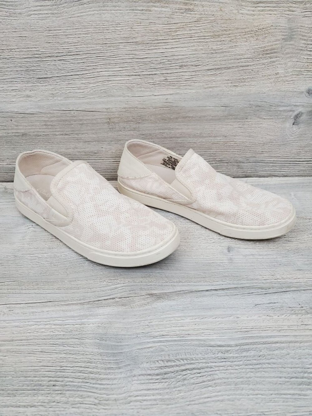 OluKai Pehuea drop-in flats in Puka/White; slip on